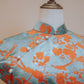 Green and orange jacquard cheongsam with pointed sleeves